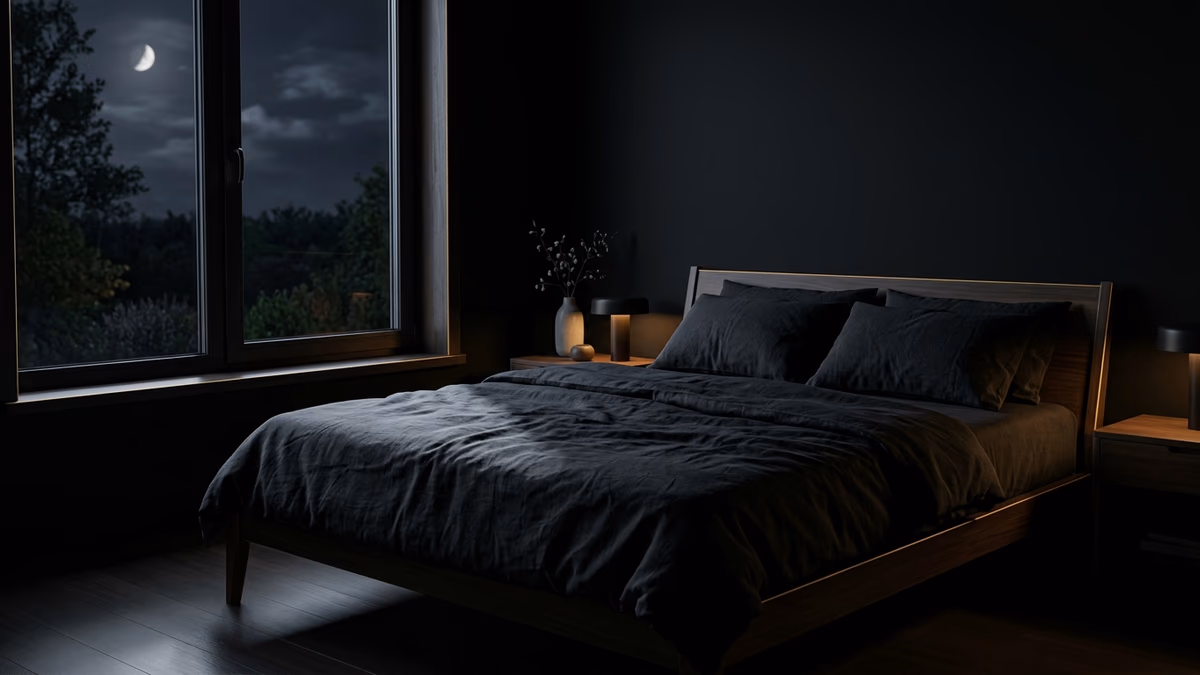 Dark, calm minimalist bedroom at night representing sleep optimization for sharper focus and recovery